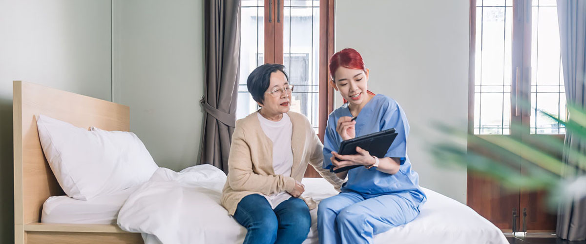 Woman nurse wearing scrubs report the health status of Senior woman