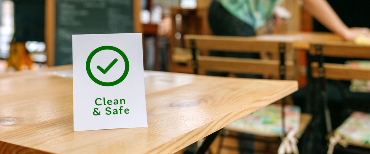 Clean and Safe sign placed on a table