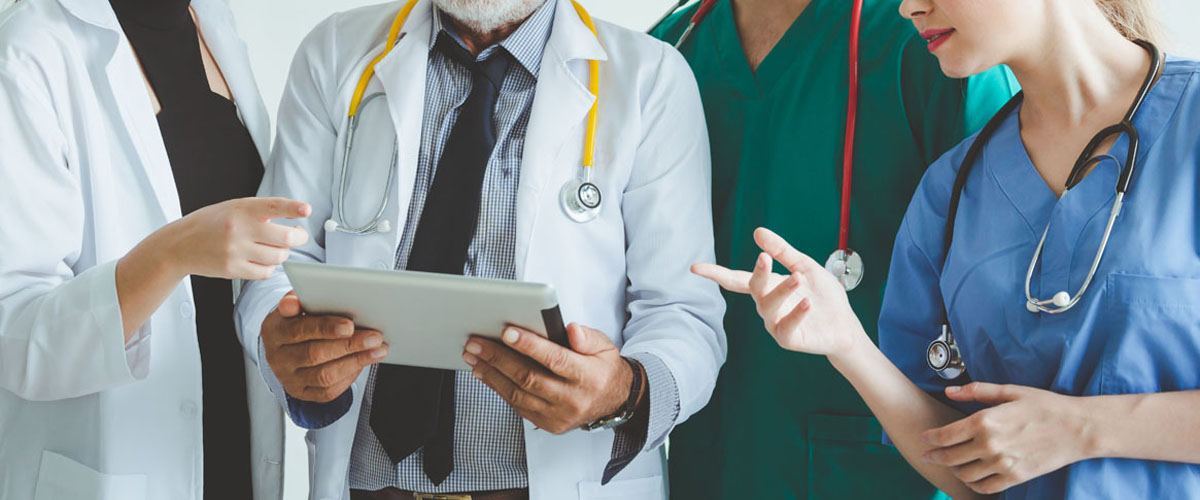 Group of doctors with tablet