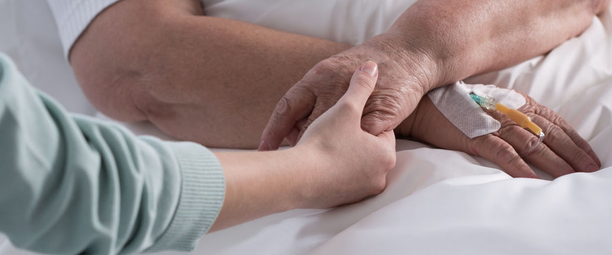 Female holding cancer patient hand