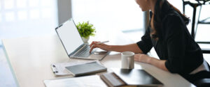 Female entrepreneur working on laptop computer in the office.