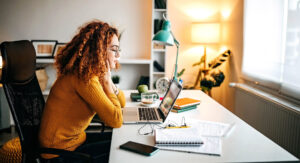 Woman learning at a laptop from home